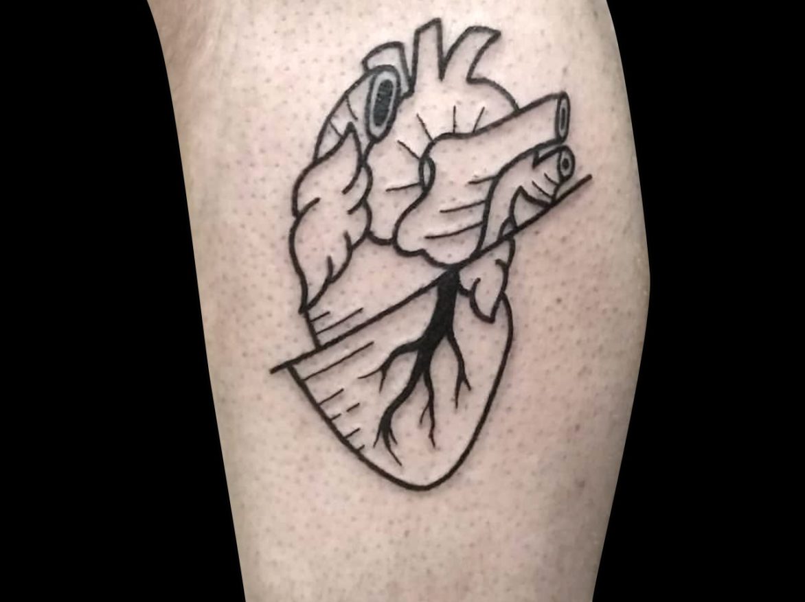 blackwork simple outline out anatomical heart with diagonal line bisecting it tattoed on side of calf