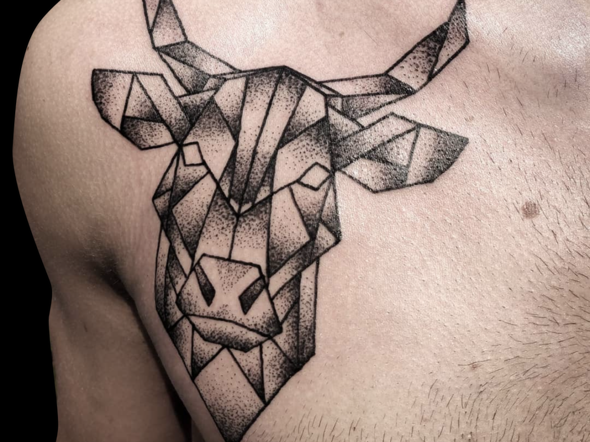 dotwork tattoo of geometric bull head tattooed on front of chest and shaded with dots